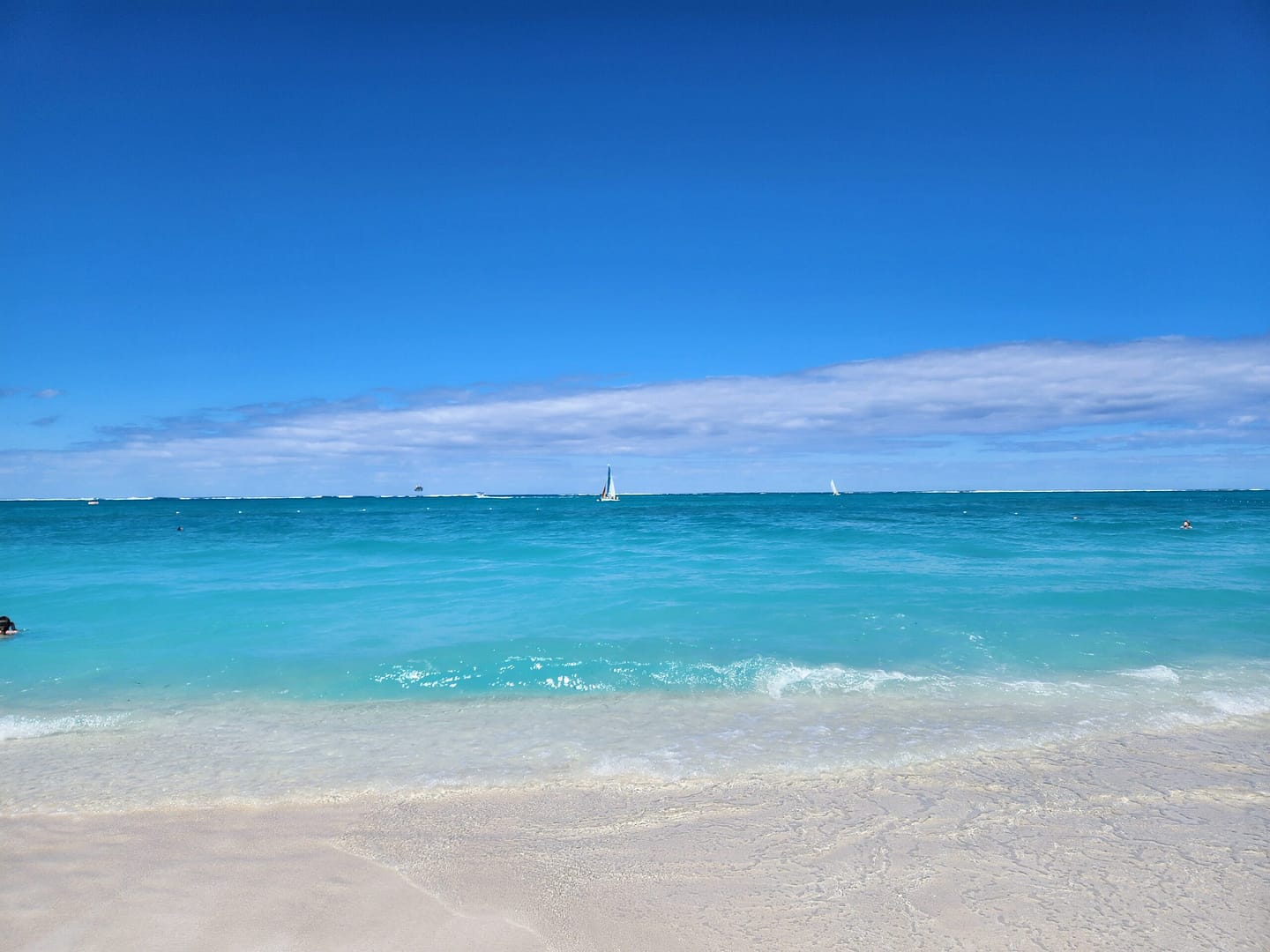 White sand beach with turquoise water and bright blue sky