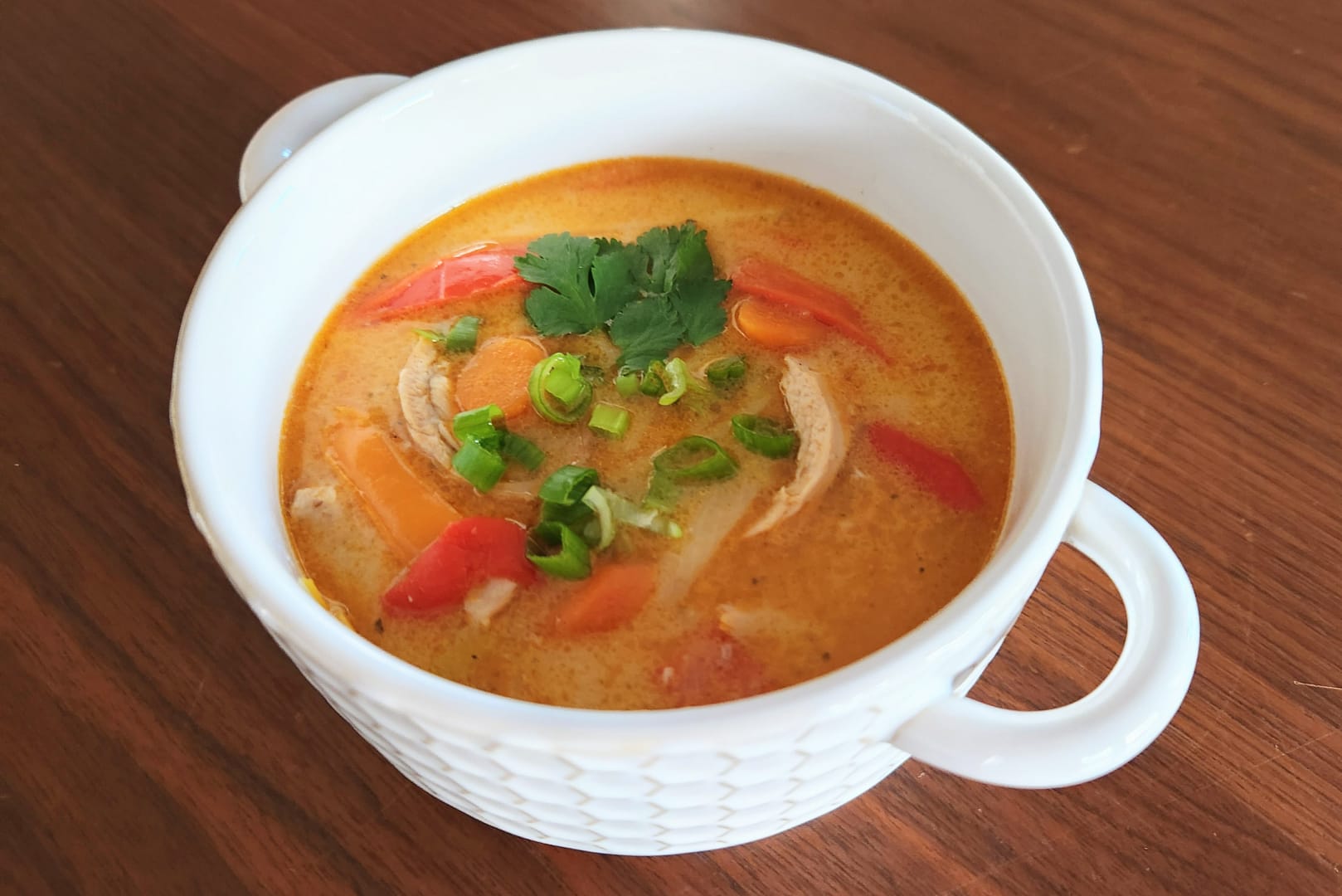 A bowl of Thai-inspired chicken curry soup