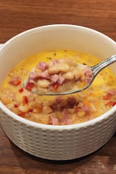 Bowl of soup with ham and white beans