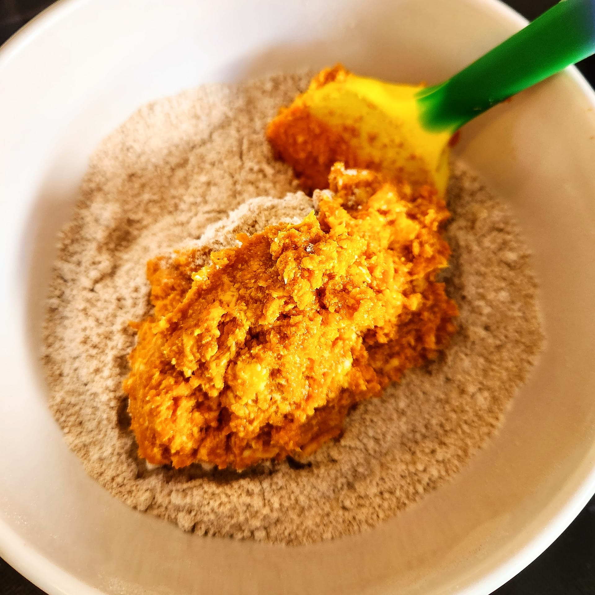 Pumpkin cookie dough being mixed in a bowl